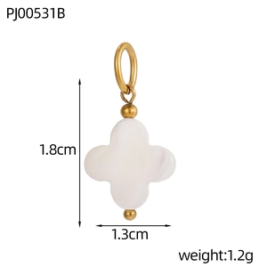 Detail of four-leaf clover pendant with white stone inlay and gold metal accents