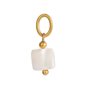 Detailed macro view of star pendant with golden metal finish and white pearl shell inlay