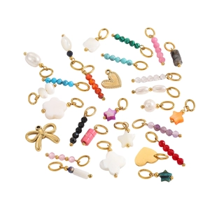 DIY jewelry charms set with pearls and star pendants on a clean white background