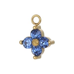Detailed close-up of a blue zircon flower pendant with four faceted petals and golden center