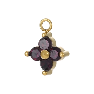 Macro detail of a gold four-leaf flower pendant with deep purple round gemstones