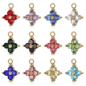 Detailed view of colorful four-petal flower charms with golden metal base and cubic zirconia