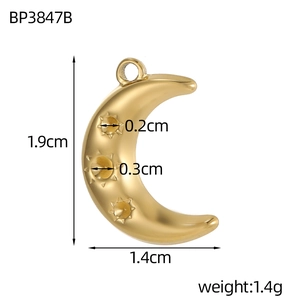 Macro shot of gold crescent moon pendant with star motifs and dimensions shown