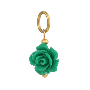 Close-up of green resin rose pendant with golden metal ring and beads for jewelry making