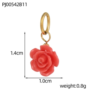 Macro shot of pink resin rose pendant with gold metal ring measuring 1.4cm by 1.0cm