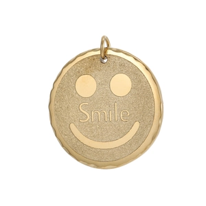 Macro view of gold round pendant with Smile engraving and textured matte finish
