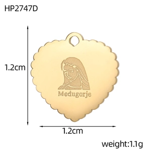 Detailed view of heart-shaped gold pendant with Medugorje engraving and scalloped edges