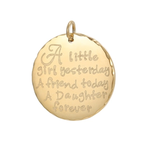 Detail of round gold pendant with irregular edges and sentimental daughter engraving