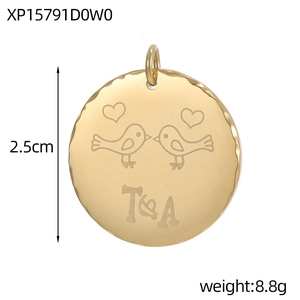 Macro view of 2.5cm gold stainless steel pendant with bird engraving and T&A initials