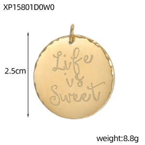 Macro view of a 2.5cm vintage gold Life is Sweet engraved charm with wavy edges