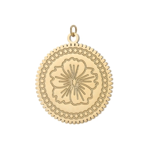 Macro view of vintage gold-plated round pendant with engraved floral pattern