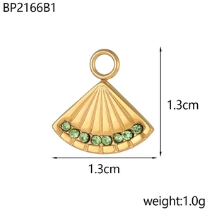 Detailed view of fan-shaped gold pendant with green rhinestones and size measurements