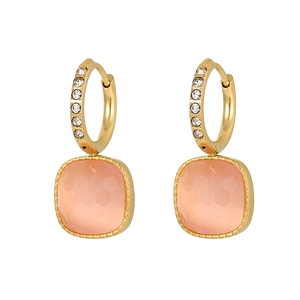 Detail of square faceted orange stone earrings with zircon pavé gold hoops