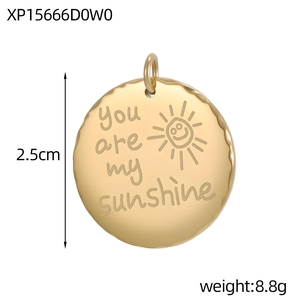 Detail of round gold pendant with You are my sunshine engraving and 2.5cm diameter measure
