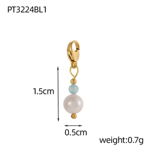 Macro shot of gold pendant featuring a light blue faceted bead and white pearl, 1.5cm high