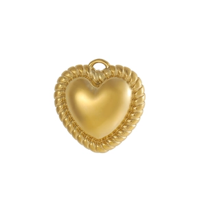 Close-up of golden heart pendant with polished surface and twisted rope edge detail