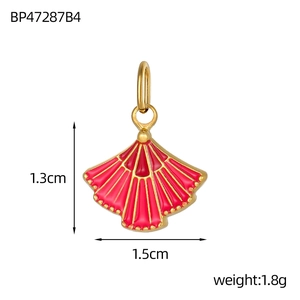 Detail view of a gold-plated fan charm with red enamel and dimension measurements