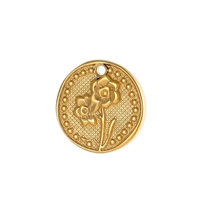 Macro detail of a vintage gold floral relief pendant with intricate grid texture and dots