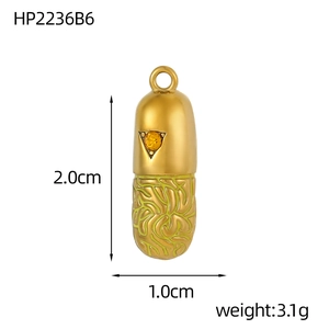Detail view of a gold capsule pendant with star engraving and green texture inlay