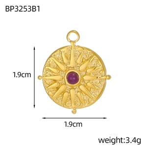 Macro detail of gold vintage tarot pendant featuring sunburst pattern and purple zircon