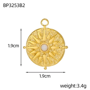 Macro detail of French tarot sun medallion in gold stainless steel with zircon inlay