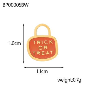 Detail of orange enamel pumpkin charm with Trick or Treat hollow lettering and gold edges
