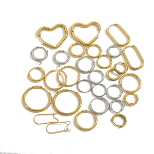 Collection of gold and silver stainless steel earrings in hoop, heart, and U-shapes