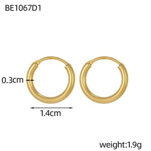 Detail view of gold hoop earrings showing 1.4cm diameter and 0.3cm tube thickness