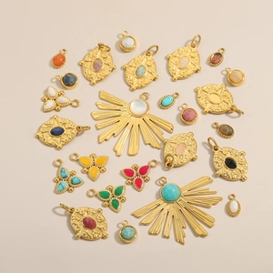 Vintage gold metal pendants with turquoise and tiger eye stones in bohemian style