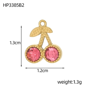 Macro view of gold cherry pendant with pink crystal and detailed measurements in centimeters