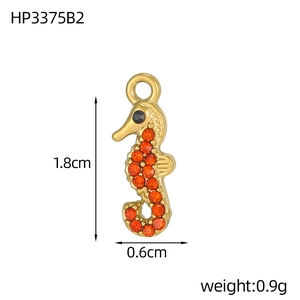 Detail of seahorse pendant in gold finish with orange stones, size 1.8cm by 0.6cm