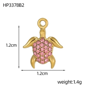 Macro shot of 1.2cm gold turtle pendant with pink crystals showing dimensions and weight