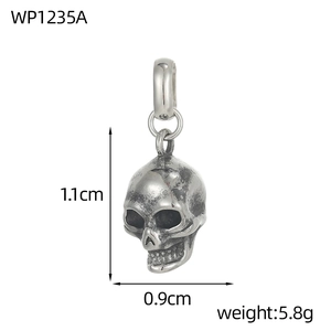 Macro view of vintage silver skull pendant showing detailed 1.1cm height measurements