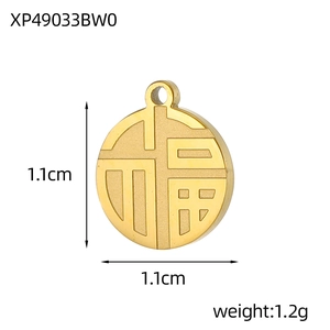 Macro detail of a 1.1cm golden round Fu pendant with traditional Chinese engraving