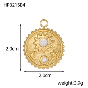 Detailed macro view of 2cm gold celestial pendant with sun, moon, and inlaid zircon