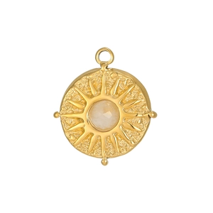 Macro shot of gold stainless steel sunburst pendant with zircon stone and rock texture