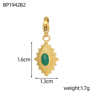 Macro view of gold stainless steel devil eye pendant with green stone and clasp