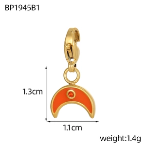 Detail of crescent moon pendant with orange enamel and red crystal, 1.3cm x 1.1cm size