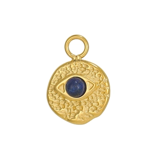 Detail of bohemian evil eye pendant with blue natural stone and hammered gold finish