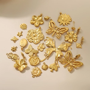 French style gold plated stainless steel charms featuring butterfly and floral designs
