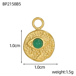 Detail of 1.0cm gold round pendant with green stone and hammered eye design