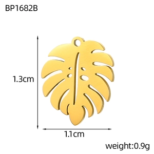Detailed macro view of gold monstera leaf pendant with brushed metal finish and dimensions