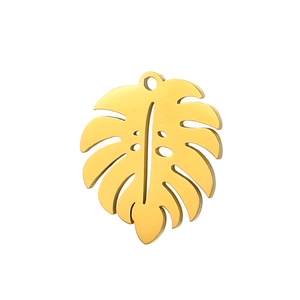 Macro detail of a golden monstera leaf pendant charm for DIY jewelry and accessories