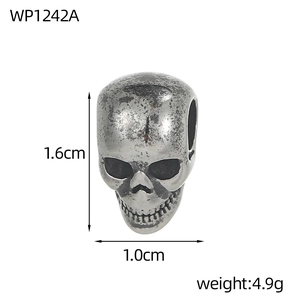 Detail view of a vintage silver skull pendant showing 1.6cm height and weight specs