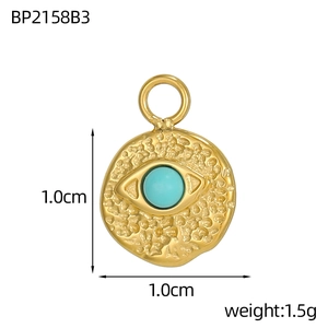 Detail of 1.5g gold round pendant with turquoise stone inlay and hammered texture