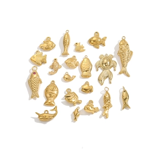 Polished gold stainless steel koi fish and sea animal charms collection on white background