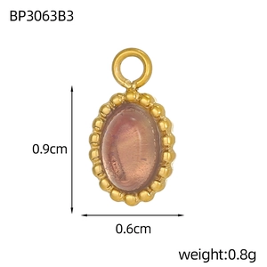 Macro detail of oval gold-plated pendant with purple stone showing dimensions 0.9cm by 0.6cm