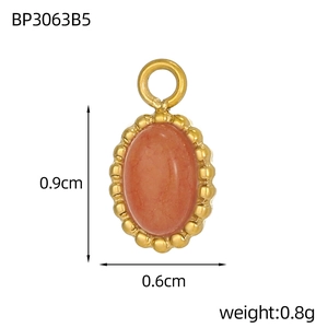 Macro detail of oval pink stone pendant with golden beaded frame and size measurements