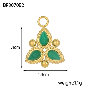 Detail view of a triangle-shaped gold pendant with green stones and dimensions 1.4cm