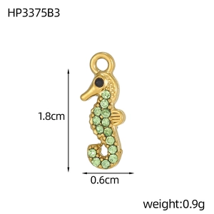 Detailed size view of a 1.8cm golden seahorse charm with green zircon stones